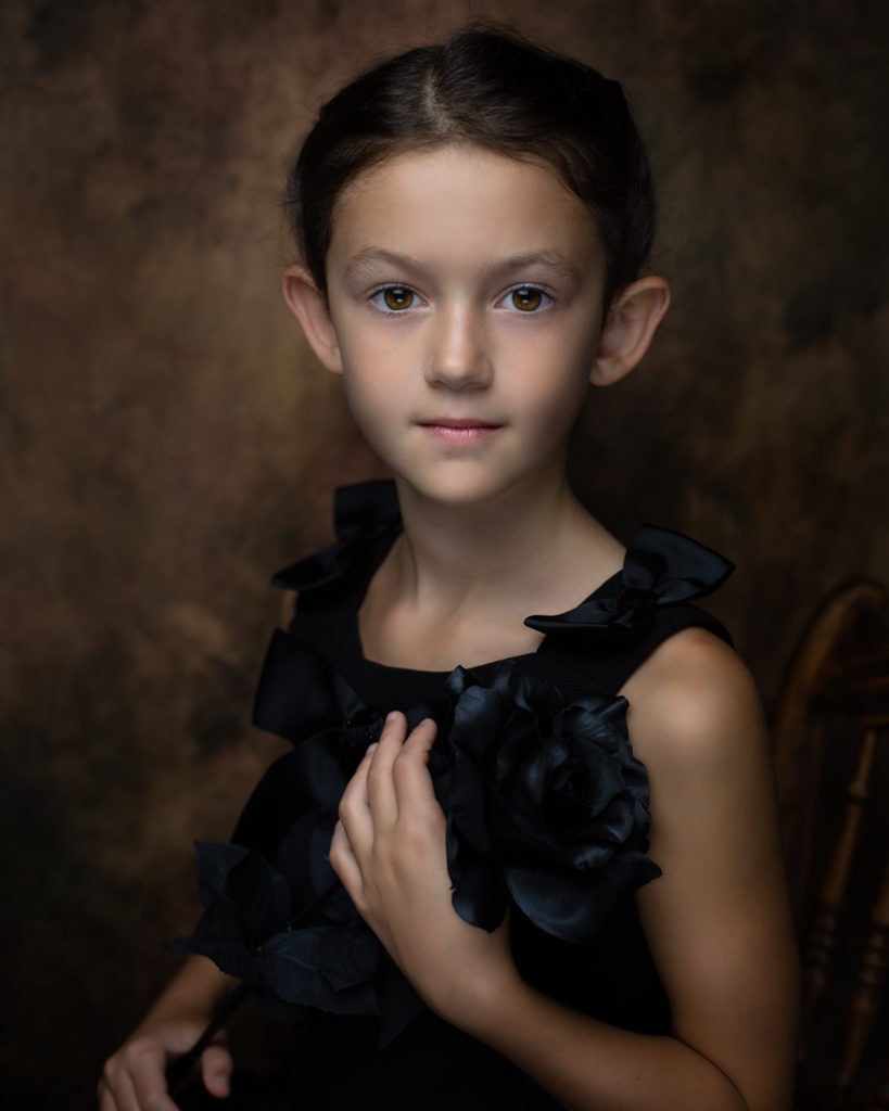 fine art portrait of a 8 year old girl traditional black dress with a rose ideas for posing in Farmington CT