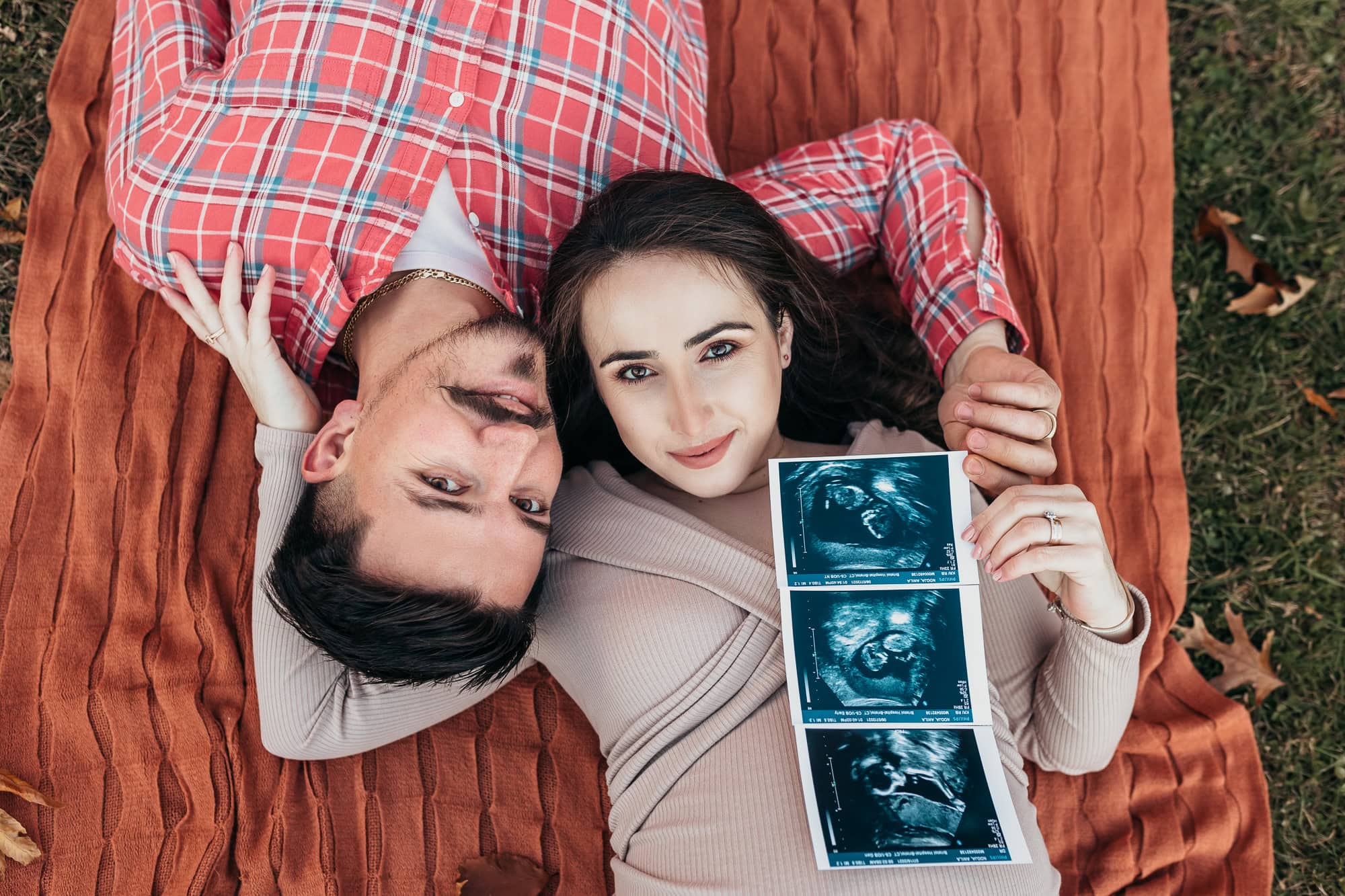 newborn photography baby girl in white posing Farmington ct side lying pose with a stuffed toy bird swan baby ballerina