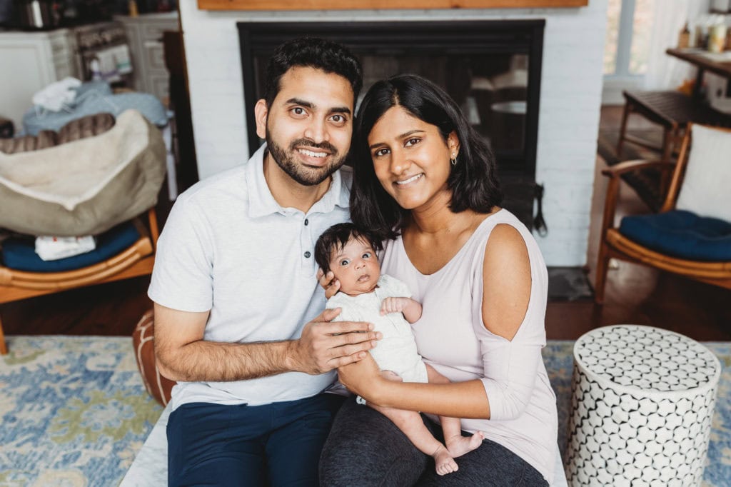 newborn posing with mom and dad older newborn 4 weeks old