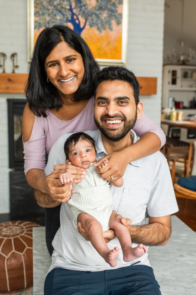 Newborn posing with parents in a house Indian newborn 