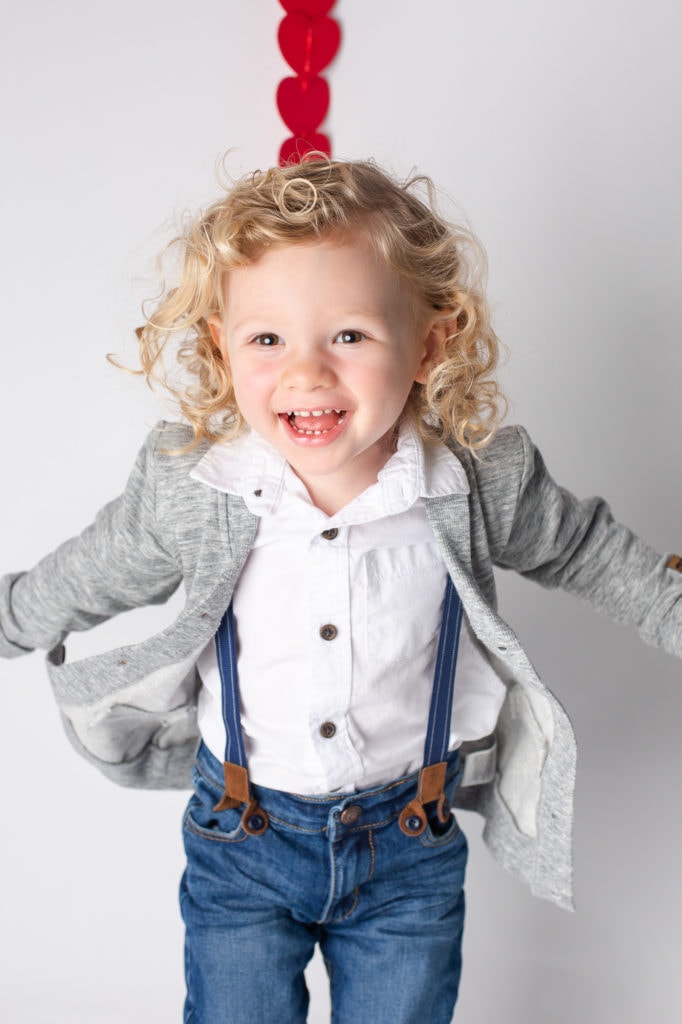 boy jumping hearts and white background