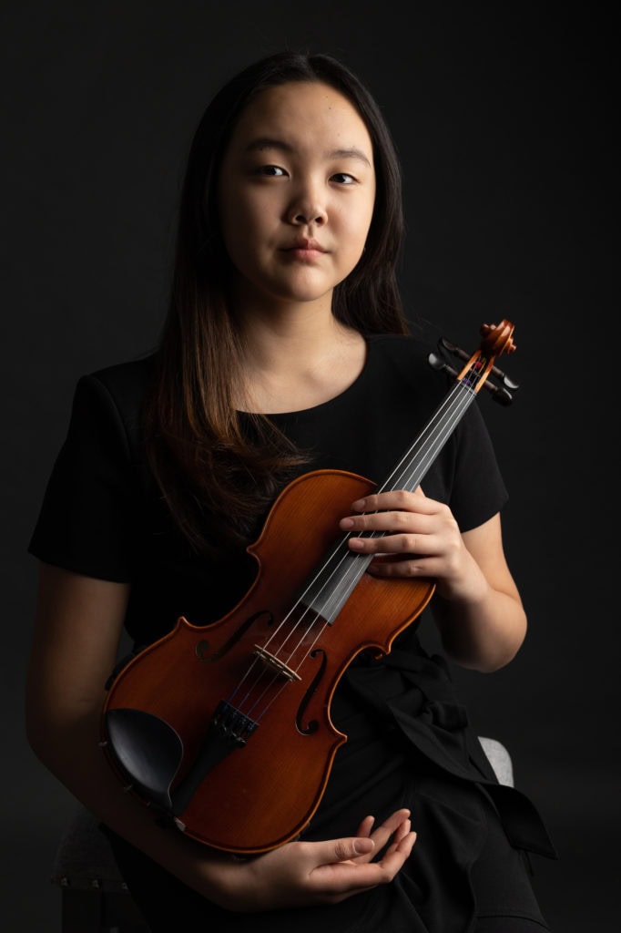 girl violin player portrait with viola dark background