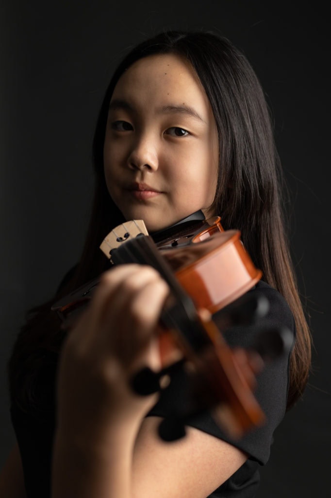 girl violin player portrait with viola dark background