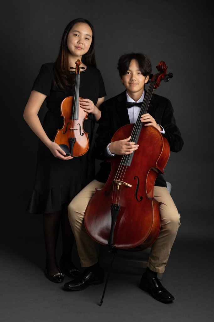 siblings musician photoshoot dark thunderstorm backdrop fine art portrait
