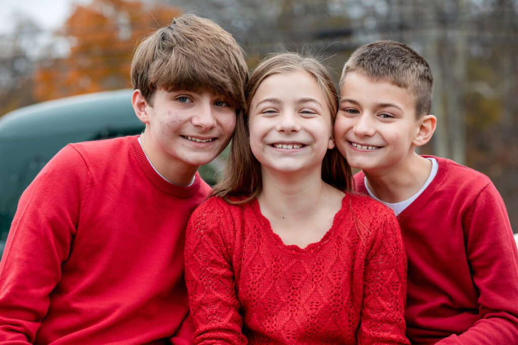 three siblings wearing red for Christmas mini session Connecticut