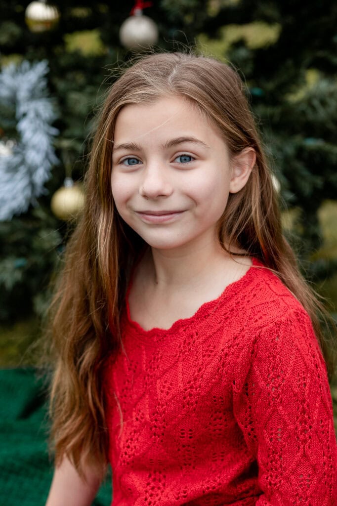 Christmas mini session girls portrait long hair wearing red dress in Connecticut