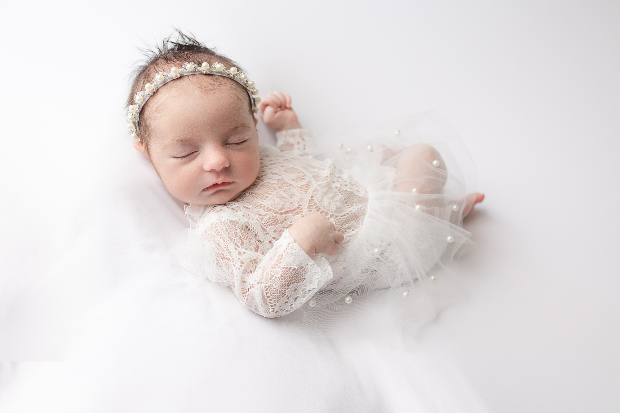 newborn photography baby girl in white posing Farmington ct huck Finn pose