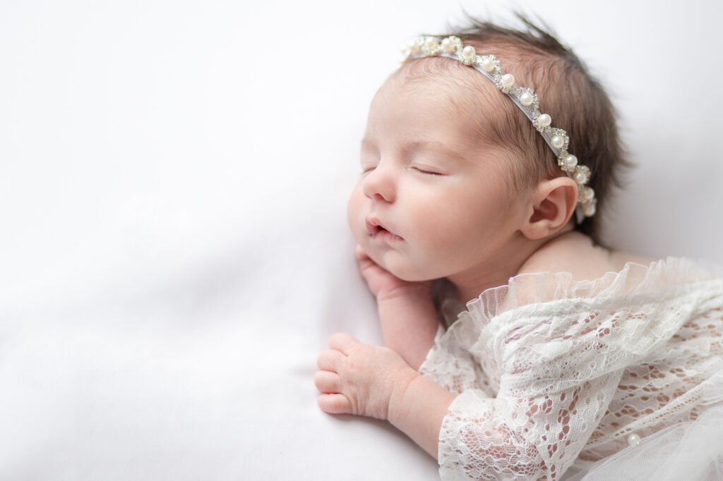 newborn photography baby girl in white posing Farmington ct side lying pose