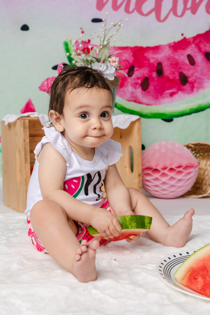 funny cake smash baby eating watermelon baby girl pink and green