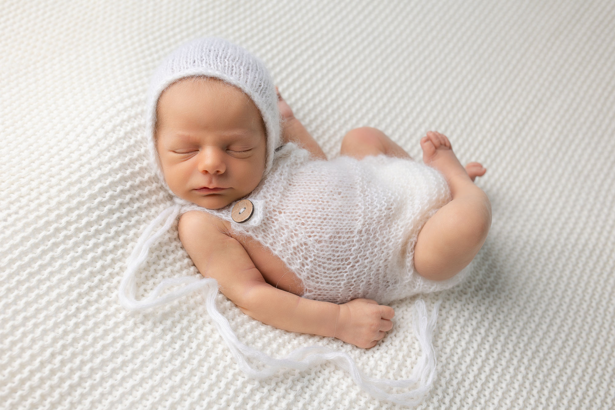 newborn hack finn pose baby boy in white