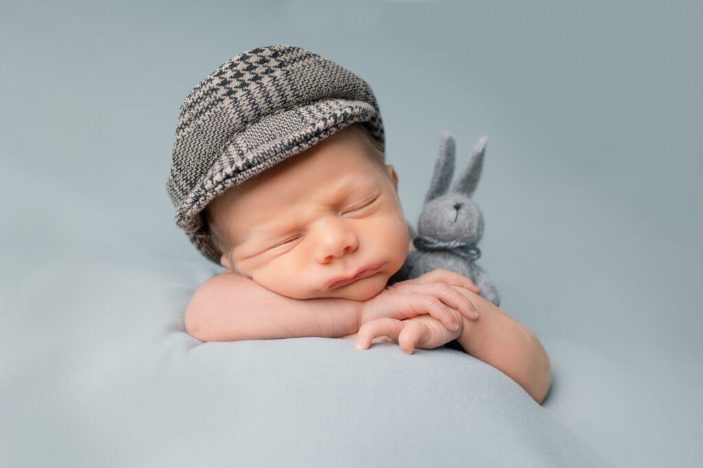 newborn posing head on hands, newborn boy with a bunny, newborn photography