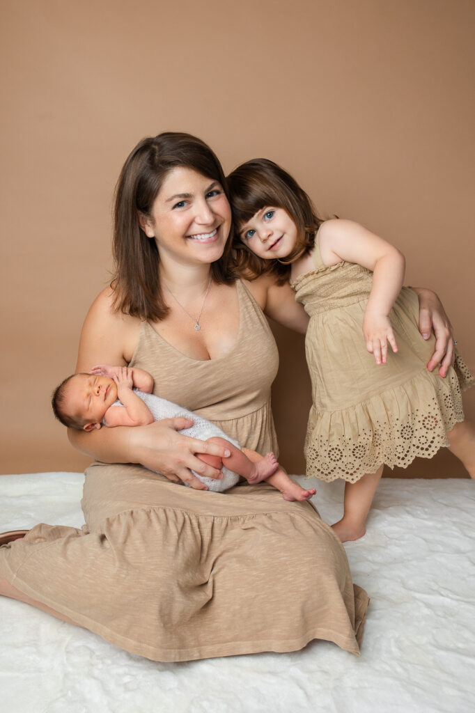 Mom with toddler and newborn, brown and beige