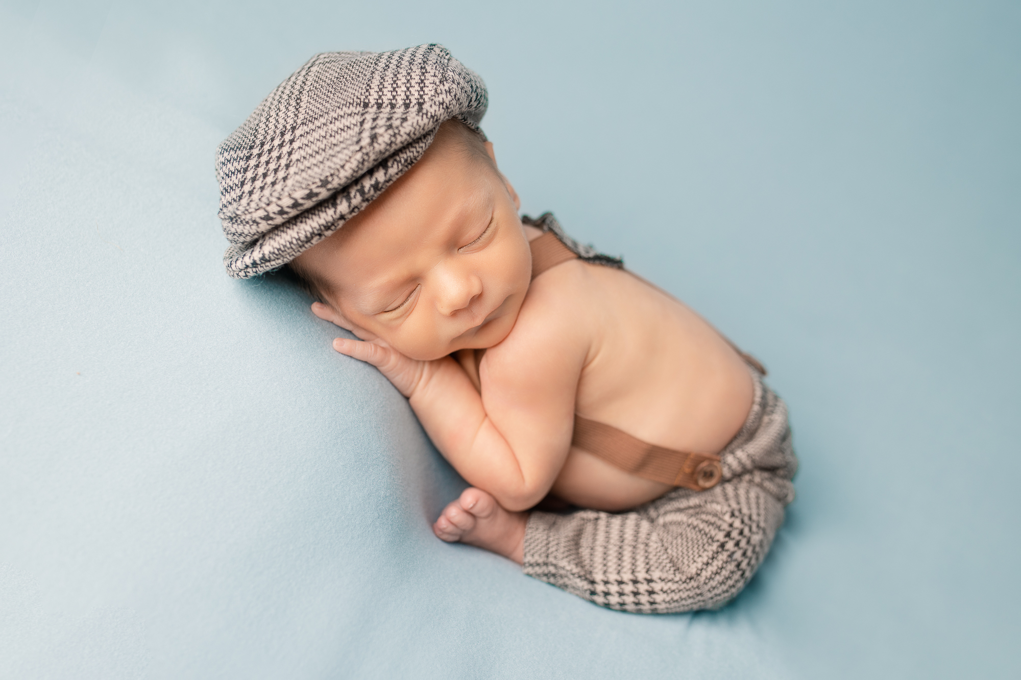 taco womb pose for newborn baby boy in gentlemen outfit