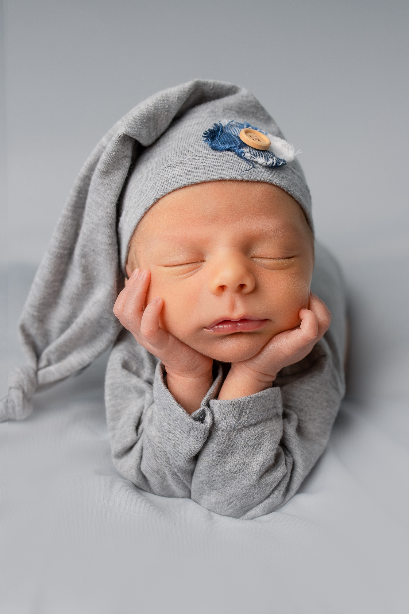 newborn baby boy froggy pose cute outfit gray