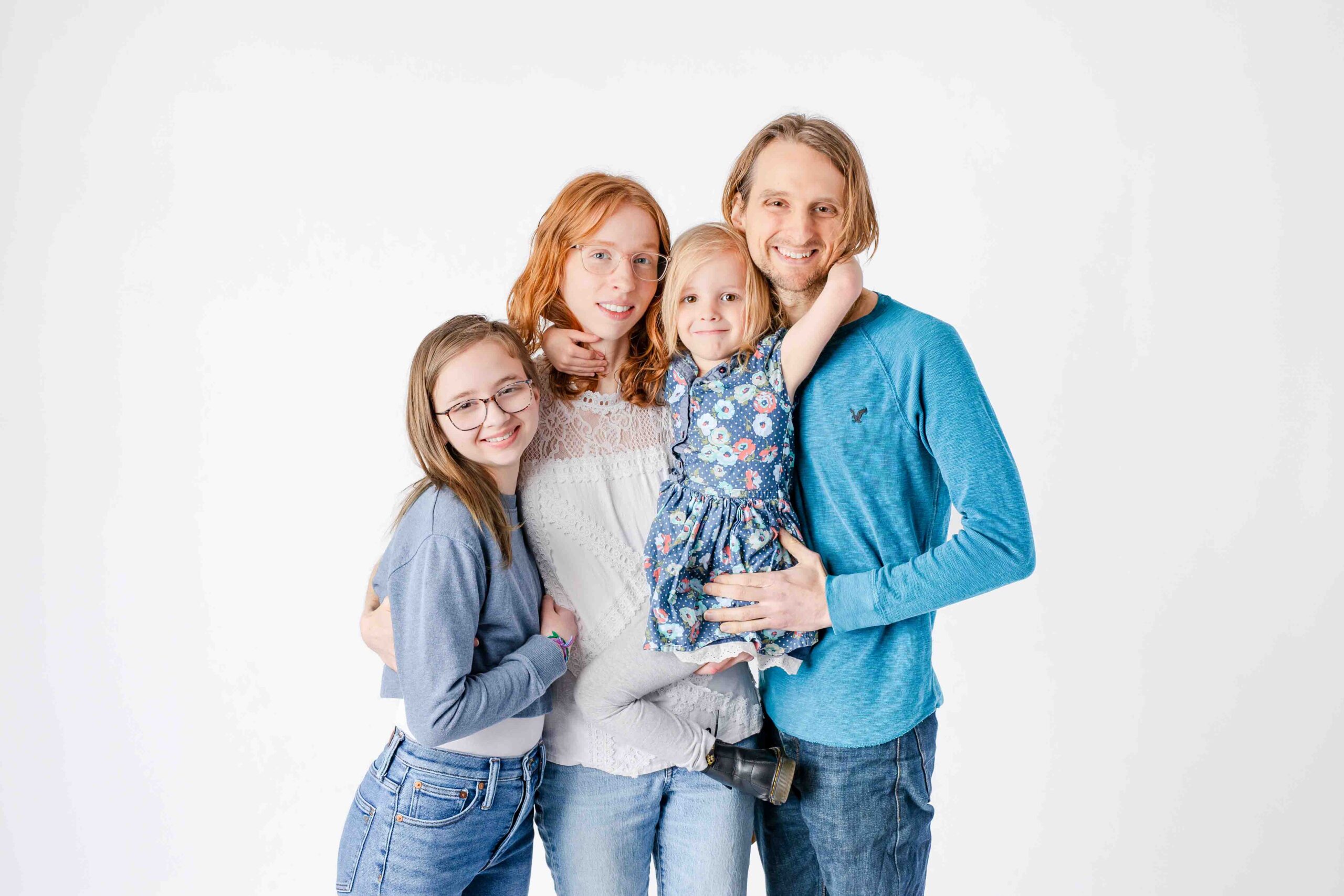 lifestyle candid newborn photography, studio family portraits, beige and brown, little girl kissing mom