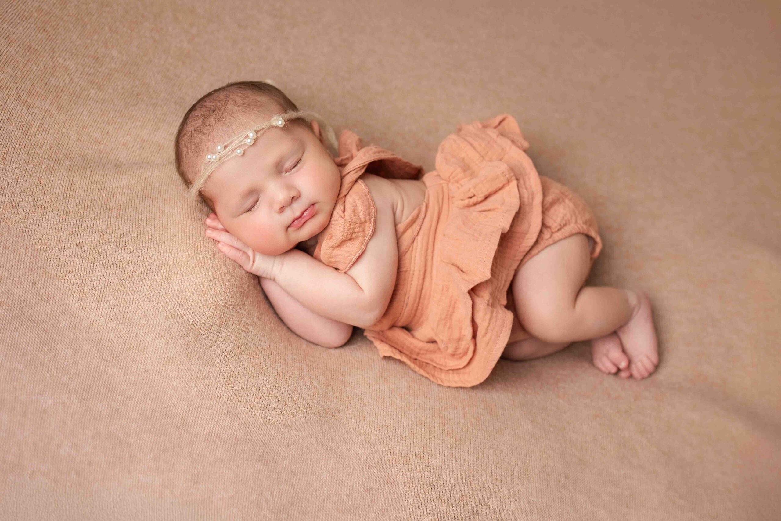 newborn photography baby girl in white posing Farmington ct huck Finn pose